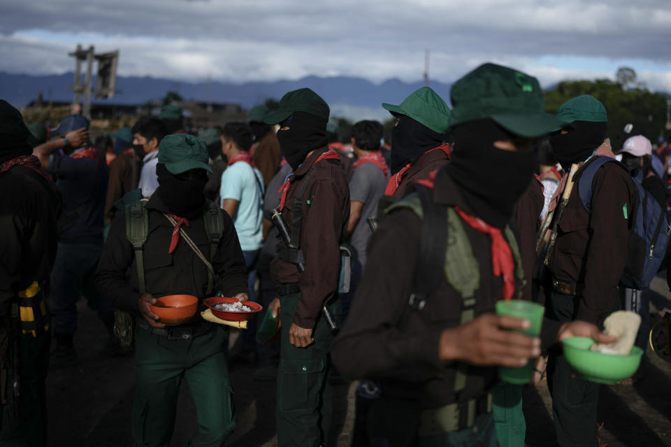 Members of the Zapatista National Liberation Army hold meals during an event marking the 30th anniversary of the Zapatista uprising in Dolores Hidalgo, Chiapas, Mexico, Sunday, Dec. 31, 2023. (AP Photo/Eduardo Verdugo)