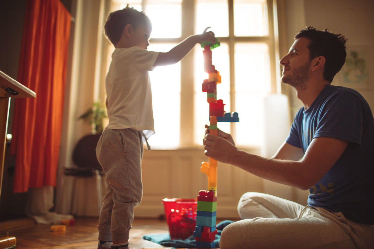 Father and child playing with blocks Getty Images/AleksandarNakic