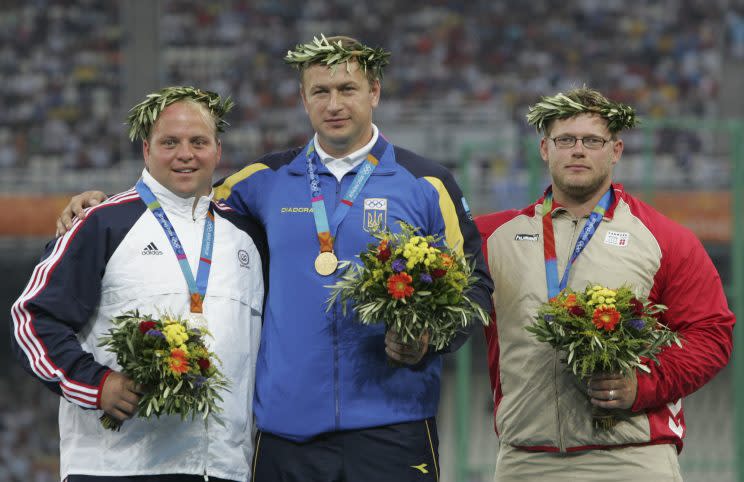 Adam Nelson, left, won silver at the 2004 Games only to be awarded gold almost a decade later. (AP)