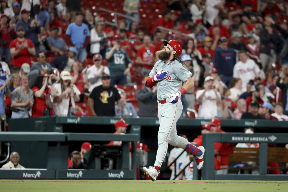 Philadelphia Phillies' Brandon Marsh gestures skyward as he runs the bases after hitting a solo home run during the eighth inning of a baseball game against the St. Louis Cardinals Monday, April 8, 2024, in St. Louis. (AP Photo/Scott Kane)