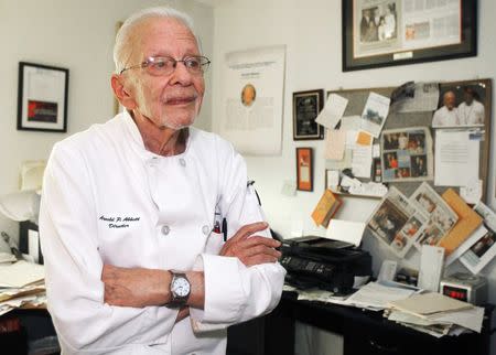 Arnold P. Abbott, president of the Maureen A. Abbott Love Thy Neighbor Fund, Inc., and culinary skills training program, organisations that feed and educate the homeless, poses in the office area of his home in Oakland Park, Florida, November 6, 2014. REUTERS/Andrew Innerarity