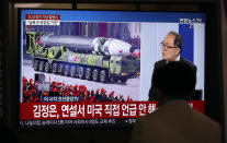 A man watches a TV screen during a news program reporting about the military parade to mark the 75th founding anniversary of the North Korea's ruling Workers' party, at the Seoul Railway Station in Seoul, South Korea, Saturday, Oct. 10, 2020. (AP Photo/Lee Jin-man)