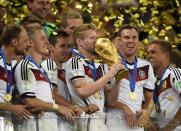 Germany's Andre Schuerrle kisses the World Cup trophy after the 2014 World Cup final between Germany and Argentina at the Maracana stadium in Rio de Janeiro July 13, 2014. REUTERS/Dylan Martinez (BRAZIL - Tags: SOCCER SPORT WORLD CUP)