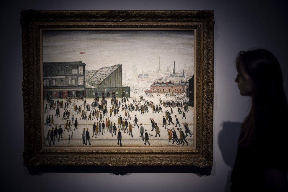 Lowry's 'Going to the Match' on display in a gallery.