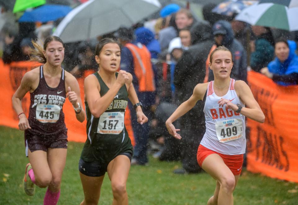Winnebago's Grace Erb (409) battles Father McGivney's Kaitlyn Hatley (157) and Pope County's Ahry Comer to take sixth-place in the Class 1A girls state cross-country meet Saturday, Nov. 5, 2022 at Detweiller Park in Peoria. Winnebago finished fourth as a team.