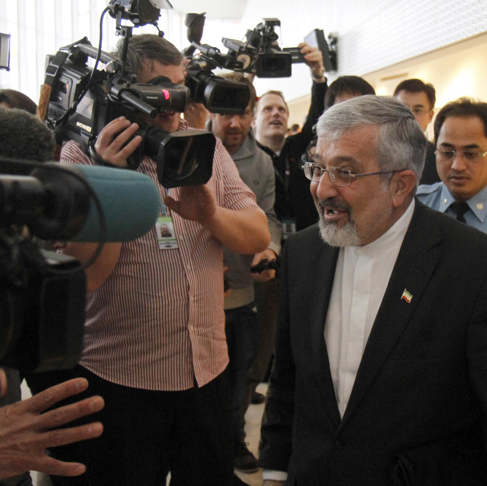 Iran's ambassador to the International Atomic Energy Agency, IAEA, Ali Asghar Soltanieh is surrounded by media and security when leaving the IAEA board of governors meeting at the International Center, in Vienna, Austria, on Thursday, March 8, 2012. (AP Photo/Ronald Zak)