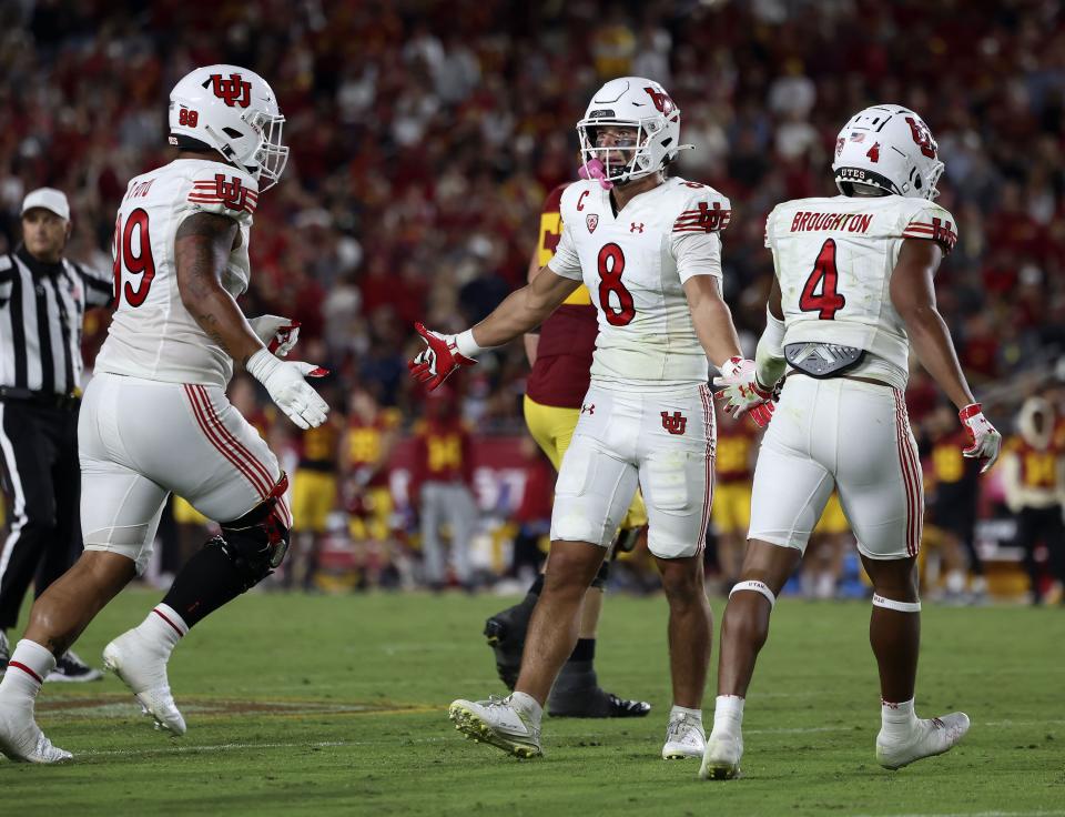 Utah Utes safety Cole Bishop (8) is congratulated by teammates after a play in the game against the USC Trojans at the Los Angeles Memorial Coliseum on Saturday, Oct. 21, 2023. | Laura Seitz, Deseret News