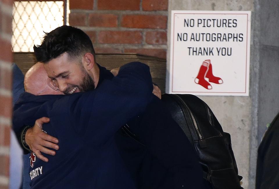 Boston Red Sox's Rick Porcello hugs a Fenway Park employee as the team arrives back in Boston, Monday, Oct. 29, 2018. The Red Sox defeated the Los Angeles Dodgers on Sunday in Los Angeles to take the 2018 World Series championship. (AP Photo/Michael Dwyer)