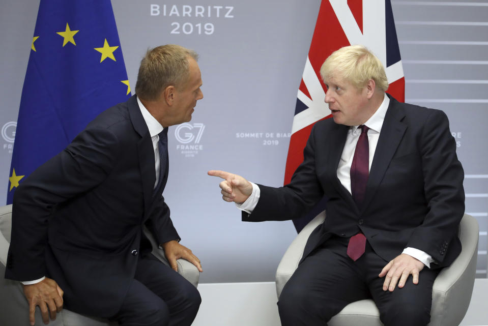 File - In this Sunday, Aug. 25, 2019 file photo, Britain's Prime Minister Boris Johnson, right, and President of the European Council Donald Tusk chat before a meeting on the side of the G-7 summit in Biarritz, France. With negotiations on the UK's departure terms from the EU hanging precariously in the balance at a time when silence seemed golden, both sides broke the spell Tuesday, Oct. 8, 2019 when Tusk directly addressed Johnson on Twitter and gave him his fill about the fast crumbling Brexit negotiations. (AP Photo/Markus Schreiber, File)