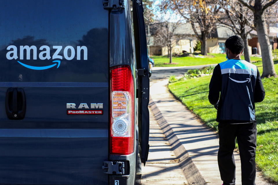 An Amazon worker delivers packages amid the coronavirus disease (COVID-19) outbreak in Denver, Colorado, U.S., April 22, 2020. Picture taken April 22, 2020. REUTERS/Kevin Mohatt