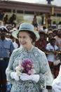 <p>Elizabeth wears a blue floral ensemble while holding a bouquet for a royal trip to Port Moresby, Papua New Guinea.<br></p>