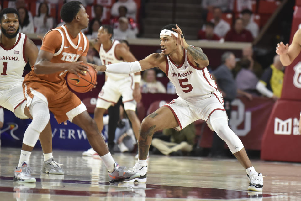 Oklahoma guard Rivaldo Soares, right, tries to steal the ball from Texas guard Max Abmas, left, during the first half of an NCAA college basketball game Tuesday, Jan. 23, 2024, in Norman, Okla. (AP Photo/Kyle Phillips)