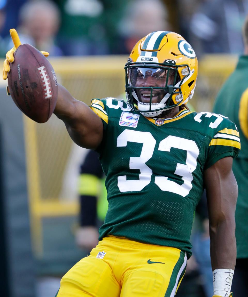 Green Bay Packers running back Aaron Jones (33) celebrates a first down against New England Patriots on Sunday, Oct. 2, at Lambeau Field in Green Bay, Wiscosin.