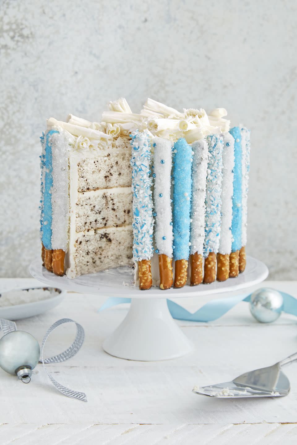 <p>While this cake looks like ready for a wintry soiree, you can coat pretzel rods in any color of candy melts and sugar to fit the theme of your party.</p><p><a href="https://www.countryliving.com/food-drinks/recipes/a40485/candied-pretzel-cake-recipe/" rel="nofollow noopener" target="_blank" data-ylk="slk:Get the recipe.;elm:context_link;itc:0;sec:content-canvas" class="link "><strong>Get the recipe.</strong></a></p>