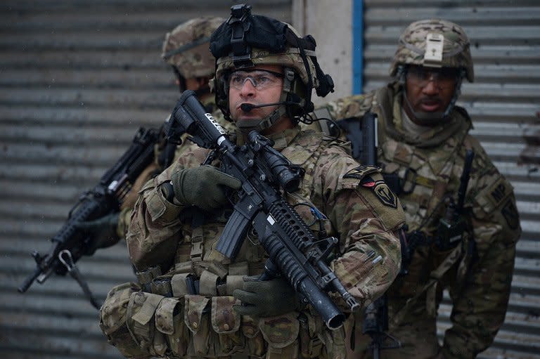 US soldiers keep watch after a suicide attack against a bus carrying Afghan army personnel in Kabul on February 27, 2013. The US commander in Afghanistan has warned troops that they face an increased threat of attack after a series of inflammatory anti-US comments by President Hamid Karzai