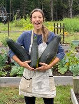 Jessica Fenescey holds some of the zucchini she grew at The Farmology Stand in Harpursville. She and her husband, Dan; grow vegetables and give them away to anyone who wants them.