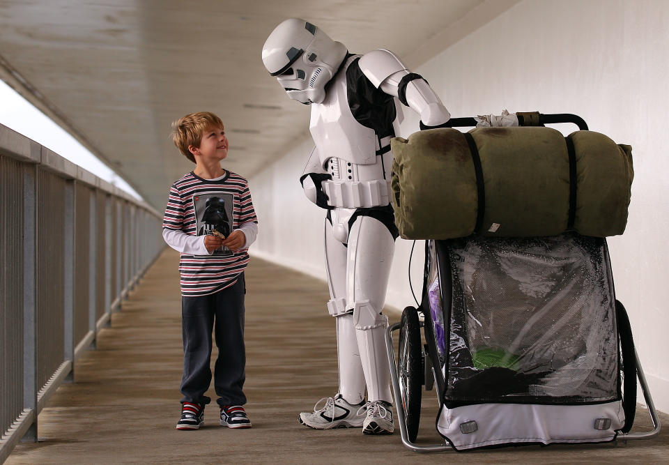 PERTH, AUSTRALIA - JULY 15: Stormtrooper Paul French is pictured on day 5 of his over 4,000 kilometre journey from Perth to Sydney talking with a young Star Wars fan at Port Bouvard bridge on July 15, 2011 in Perth, Australia. French aims to walk 35-40 kilometres a day, 5 days a week, in full Stormtrooper costume until he reaches Sydney. French is walking to raise money for the Starlight Foundation - an organisation that aims to brighten the lives of ill and hostpitalised children in Australia. (Photo by Paul Kane/Getty Images)