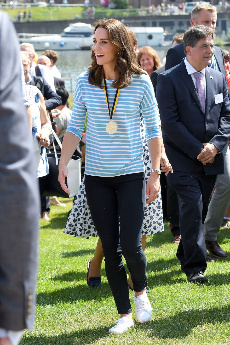 <p>In a striped Hugo Boss blue shirt, leggings and white sneakers while out in Germany. </p>