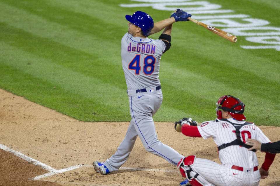 New York Mets Jacob deGrom (48) follows through on an RBI single during the fourth inning of a baseball game against the Philadelphia Phillies, Monday, April 5, 2021, in Philadelphia. (AP Photo/Laurence Kesterson)