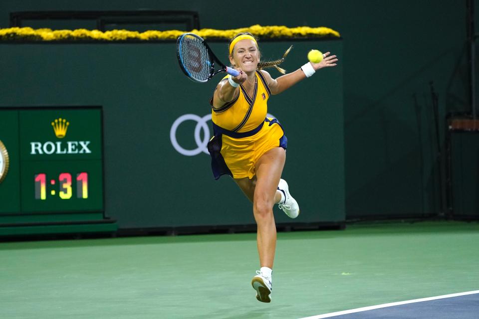 CORRECTS OPPONENT TO JELENA OSTAPENKO, INSTEAD OF ONS JABEUR - Victoria Azarenka, of Belarus, returns a shot to Jelena Ostapenko, of Latvia, at the BNP Paribas Open tennis tournament Friday, Oct. 15, 2021, in Indian Wells, Calif. (AP Photo/Mark J. Terrill)