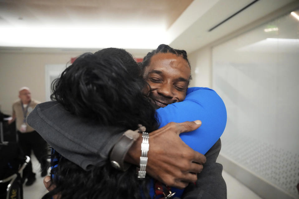 Valerie Laveus greets her brother Reginald Malherbe Daniel as he arrives for the first time to the United States from Haiti at Fort Lauderdale-Hollywood International Airport, in Fort Lauderdale, Fla., Wednesday, Aug. 9, 2023. (AP Photo/Jim Rassol)