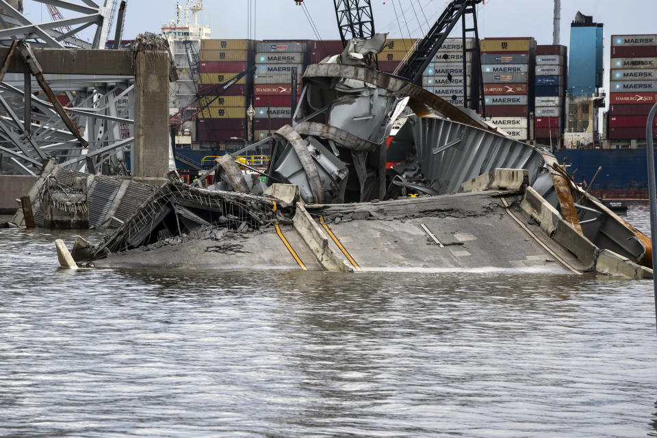 The site of the collapsed Francis Scott Key Bridge and the container ship that toppled it, Dali, are seen from the debris retrieval vessel Reynolds, April 4, 2024, in Baltimore. (Kaitlin Newman/The Baltimore Banner via AP)