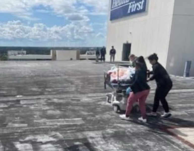 U.S. Coast Guard officials released this photo of medical personnel wheeling a man from the Carnival Sunshine on a stretcher at the Holmes Regional Medical Center helicopter landing pad in Melbourne.
