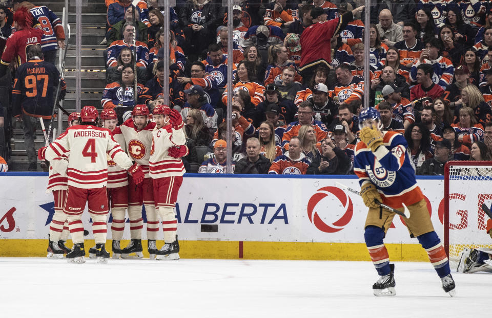 Calgary Flames players celebrate a goal against the Edmonton Oilers during the second period of an NHL hockey game Saturday, Feb. 24, 2024, in Edmonton, Alberta. (Jason Franson/The Canadian Press via AP)