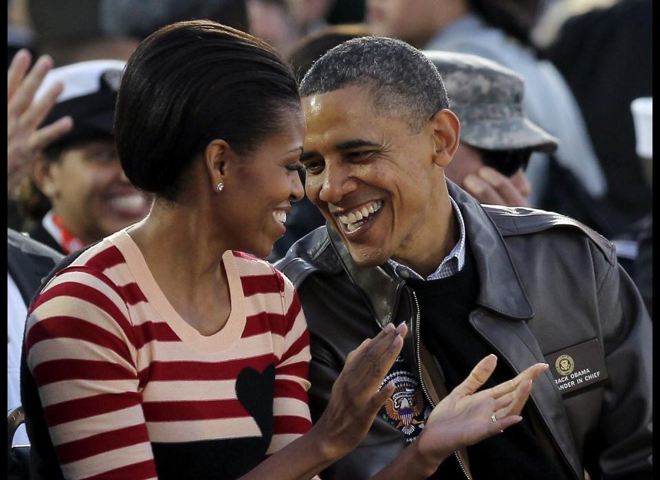 CORONADO, CA - NOVEMBER 11:  U.S. President Barack Obama and first lady Michelle Obama speak to one another during the NCAA men's college basketball Carrier Classic between the Michigan State Spartans and the North Carolina Tar Heels aboard the flight deck of the USS Carl Vinson on November 11, 2011 in San Diego, California.  (Photo by Ezra Shaw/Getty Images) 