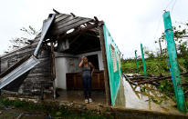 <p>A woman stands in her demolished home in Pinar del Rio, Cuba, on Sept. 27.</p>
