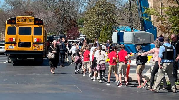 PHOTO: Children from The Covenant School, a private Christian school in Nashville, Tenn., hold hands as they are taken to a reunification site after a deadly shooting at their school, March 27, 2023. (Jonathan Mattise/AP)