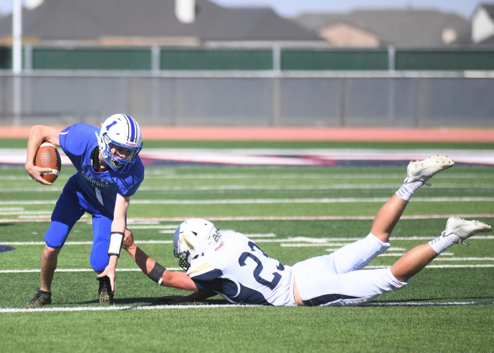 Kingdom Prep's Daniel Sell grabs Midland Trinity's Jude Varner in a game Saturday, Oct. 9, 2021, at Archie Warwick Memorial Stadium in Lubbock.