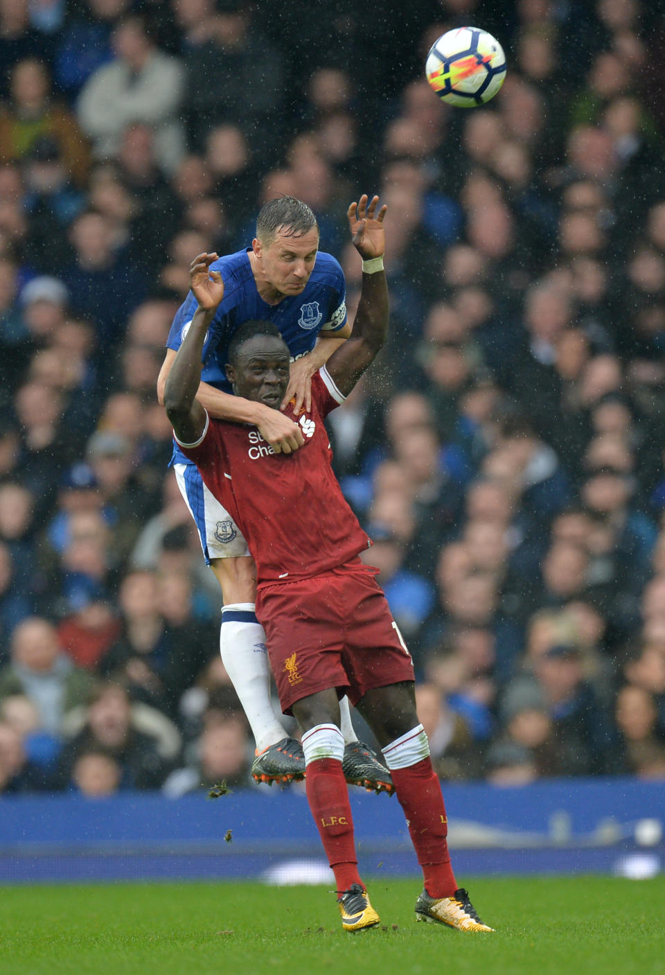 <p>Liverpool’s Sadio Mane iis held down by Everton’s Phil Jagielka </p>