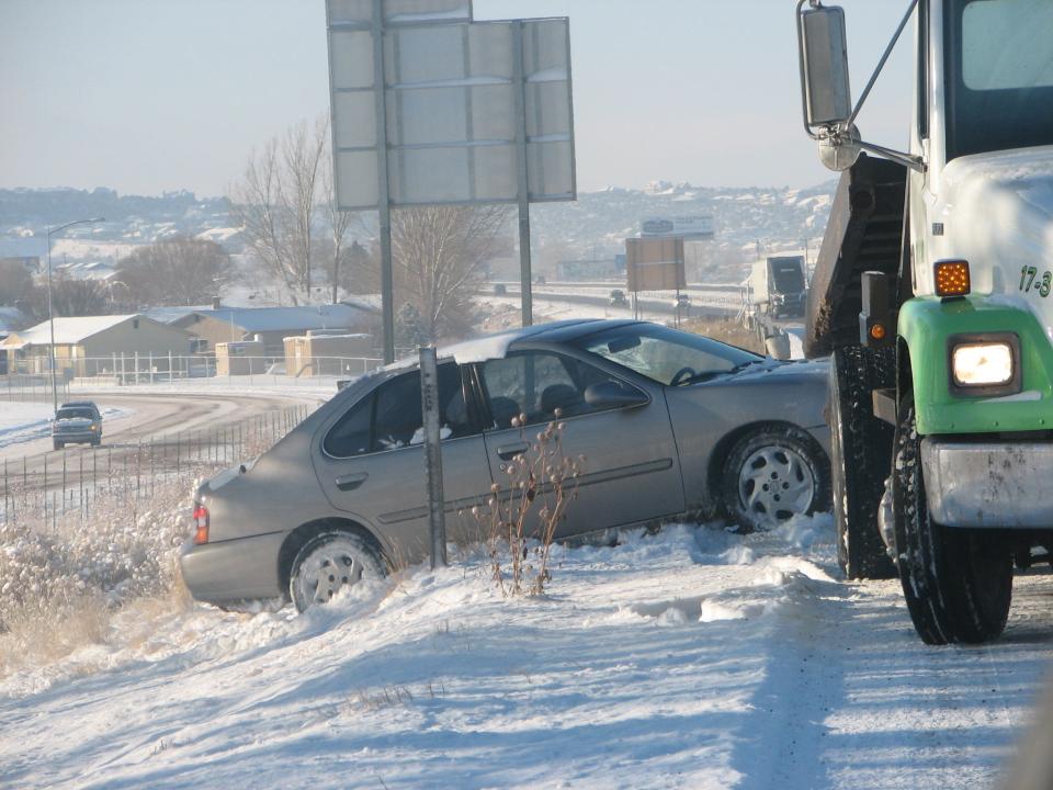 A tow truck pulls a vehicle out of the snow on Interstate 15 near Cedar City. Heavy snow is expected to hit the area this week, prompting traffic officials to urge motorists to check conditions before they travel and avoid long trips if possible.