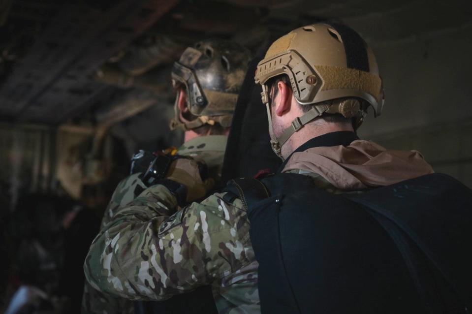 Air Force personnel onboard an MC-130J flying over the Caribbean on December 7, 2023, prepare to conduct free-fall parachute jumps. <em>USAF</em>