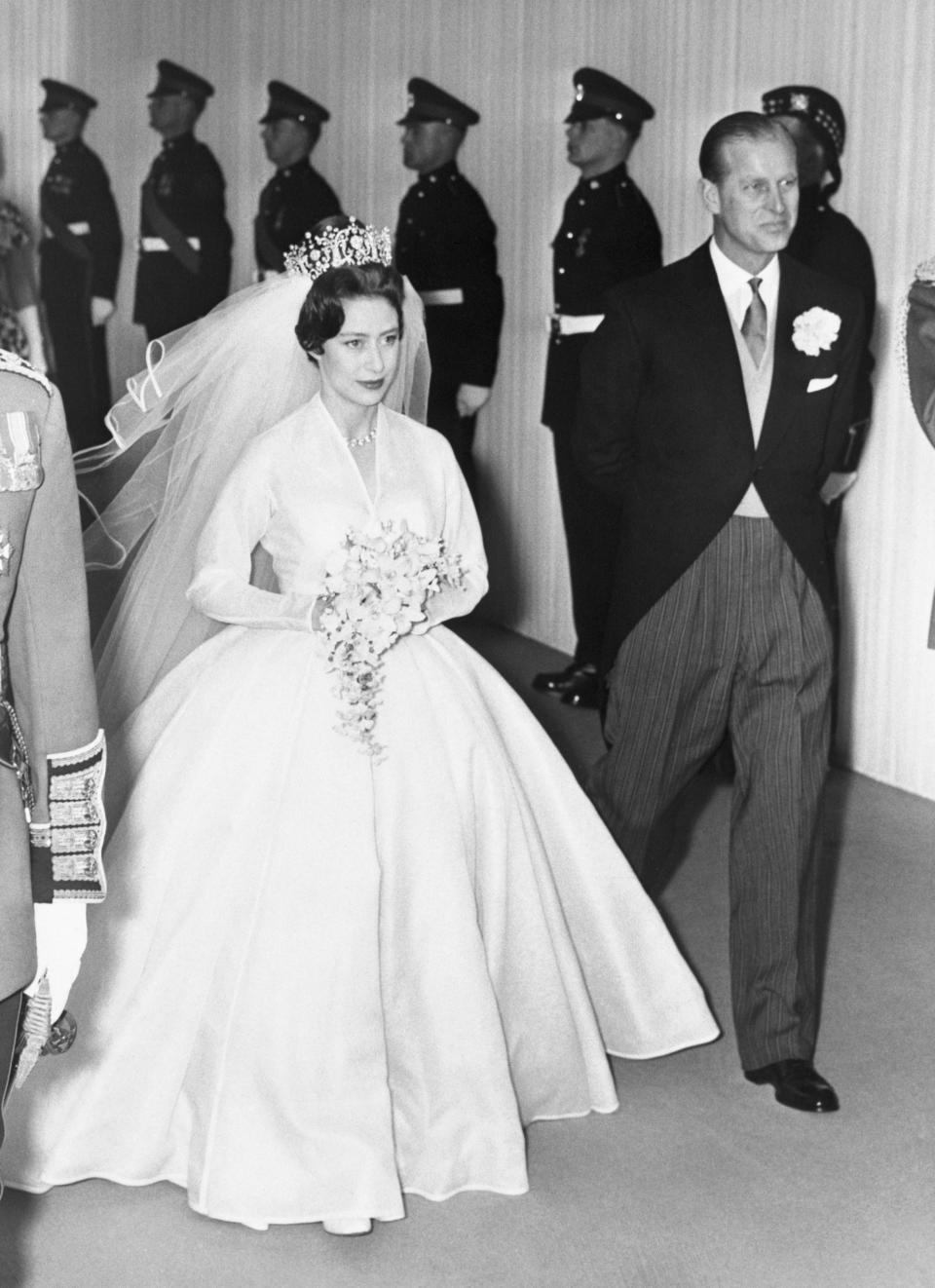 Princess Margaret is accompanied by her brother-in-law Prince Philip during her wedding to Antony Armstrong-Jones at Westminister Abbey.