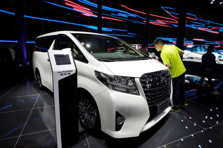 A visitor looks at a Toyota Alphard presented during the Auto China 2016 auto show in Beijing, China May 4, 2016. REUTERS/Jason Lee