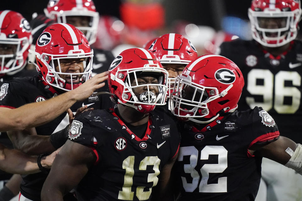 Georgia linebacker Azeez Ojulari (13) celebrates with teammates after a sack during the second half of the team's NCAA college football game against Mississippi State, Saturday, Nov. 21, 2020, in Athens, Ga. (AP Photo/Brynn Anderson)