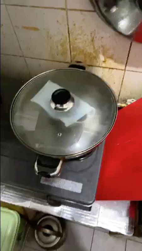 A surgical face mask is steamed in a wok to disinfect it amid the outbreak of a new coronavirus in Hong Kong