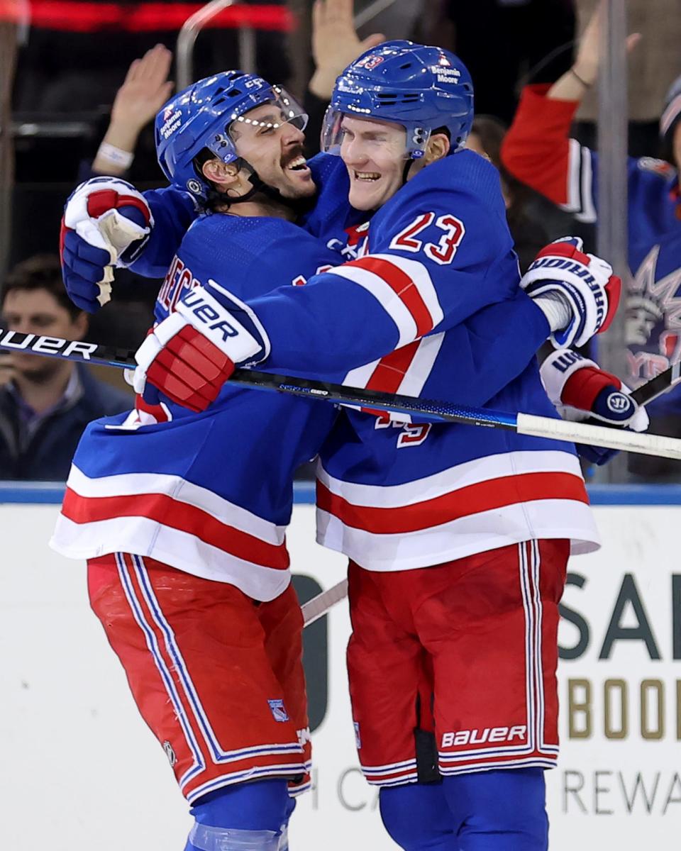 Mar 26, 2024; New York, New York, USA; New York Rangers defenseman Adam Fox (23) celebrates his game winning goal against the Philadelphia Flyers with center Vincent Trocheck (16) during overtime at Madison Square Garden.