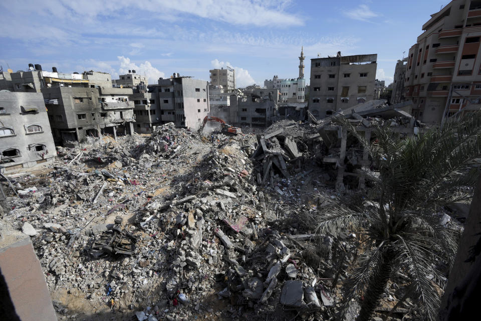 Palestinians search for the bodies of the al Meghari family killed in the Israeli bombardment of the Gaza Strip in Bureij refugee camp, Gaza Strip, Tuesday, Nov. 14, 2023. U.N. humanitarian monitors say at least 2,700 people, including 1,500 children, are missing and believed buried under the rubble. (AP Photo/Adel Hana)