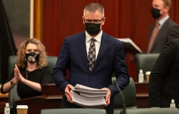 Alberta's finance minister Travis Toews prepares to deliver the 2021 budget in Edmonton on Thursday. According to economist Trevor Tombe, the province remains firmly on the resource revenue roller coaster. (Jason Franson/The Canadian Press - image credit)