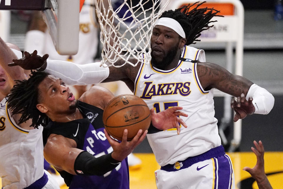 Toronto Raptors forward Freddie Gillespie, left, shoots as Los Angeles Lakers center Montrezl Harrell defends during the second half of an NBA basketball game Sunday, May 2, 2021, in Los Angeles. (AP Photo/Mark J. Terrill)