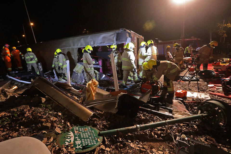 <p>Rescuers carry an injured person after a bus crashed in Hong Kong, China, Feb. 10, 2018. (Photo: Bobby Yip/Reuters) </p>