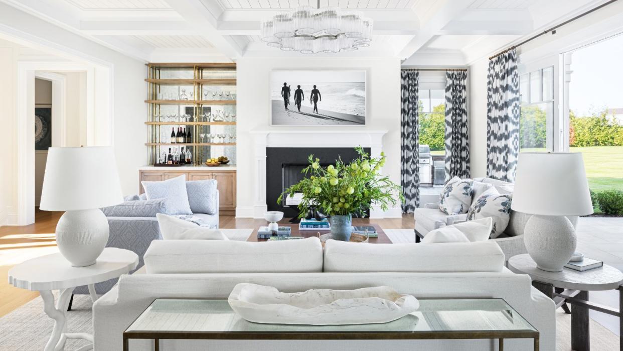  Living room with white walls and white sofa with gray accents. 