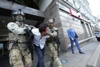 Members of the Security Service of Ukraine detain a man who threatened to blow up a bomb in a bank branch, in Kyiv