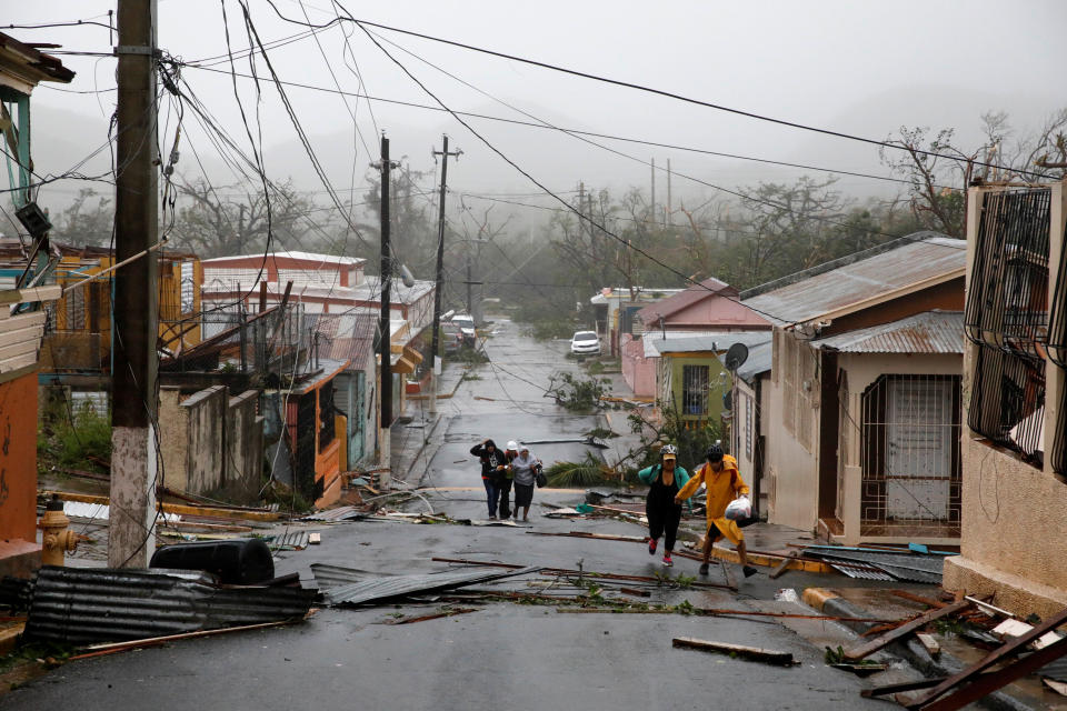 Rescue workers help people after the area was hit by Hurricane Maria.