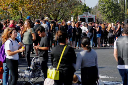 People wait in line to donate blood outside LaReina High School after a mass shooting by a lone gunman at a bar in Thousand Oaks, California, U.S. November 8, 2018. REUTERS/Mike Blake