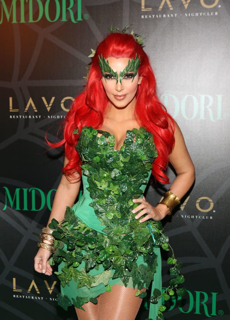 she's wearing the red wig and poison ivy leaves as a dress