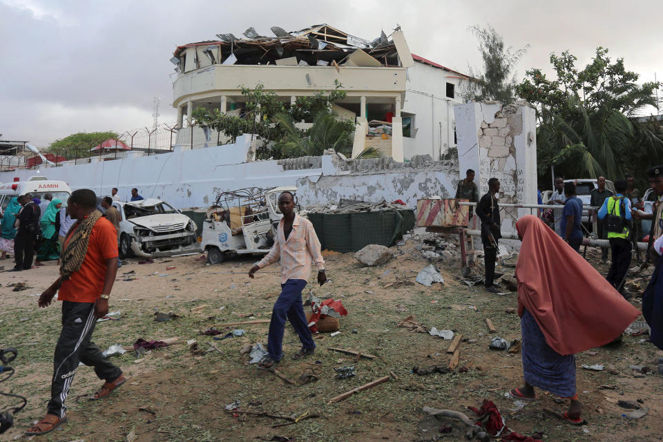 <p>People stand outside the scene of an attack on a hotel and an adjacent restaurant in Mogadishu, Somalia June 15, 2017. (Photo: Stringer/Reuters) </p>